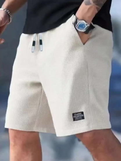 Kessoro Men's Textured Drawstring Relaxed Casual Shorts in black, khaki, beige and white — three-quarter view