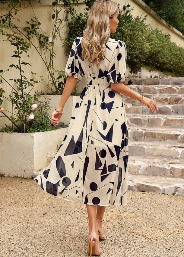 Women's floral print midi dress with a smocked waist and flowing skirt in bright multicolour shades