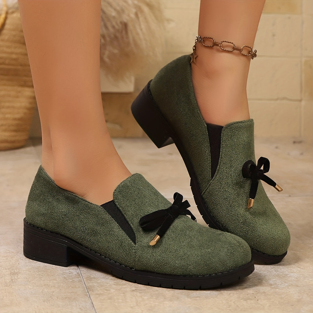 Women's bow-detail low-heel slip-on loafers in a green and black colour family (view 1)