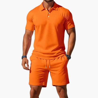 Men's classic summer polo and shorts set in blue, grey, orange and black tones, shown for menswear styling