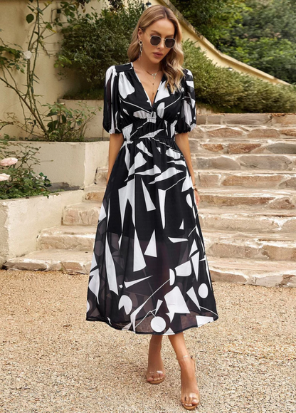 Women's floral print midi dress with a smocked waist and flowing skirt in bright multicolour shades