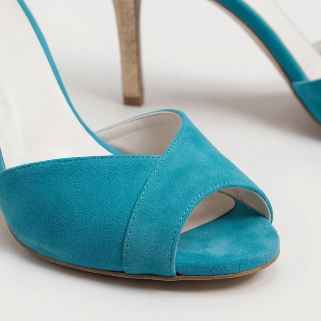 Women's teal suede strap heels with gold accents