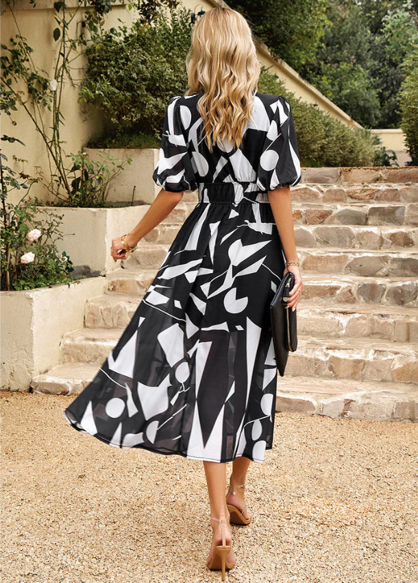 Women's floral print midi dress with a smocked waist and flowing skirt in bright multicolour shades