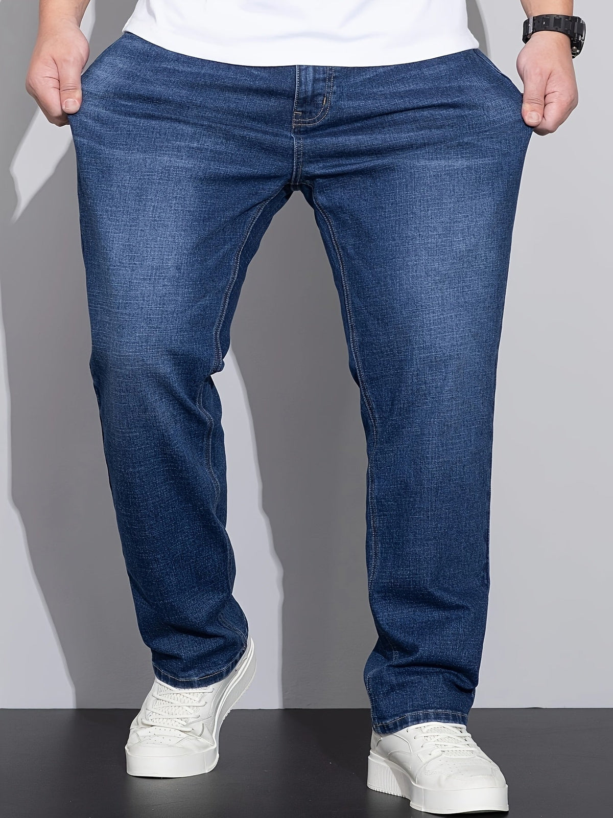 Men's mid-rise straight-leg stretch jeans in blue and black denim, side view