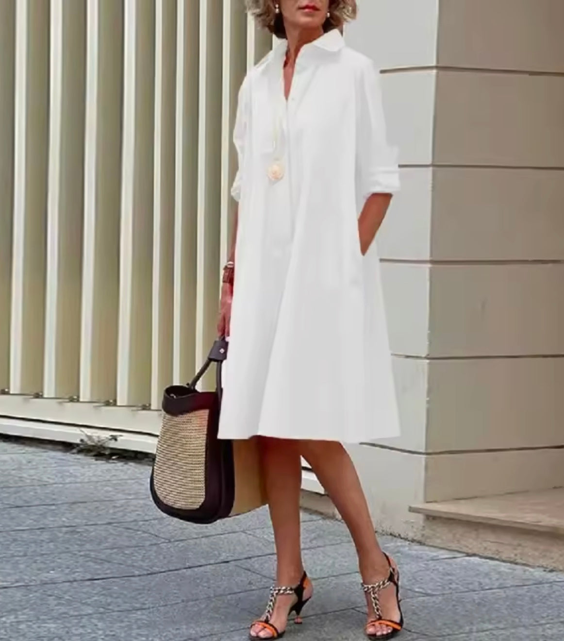 Women's collared A-line shirt dress with three-quarter sleeves and side pockets