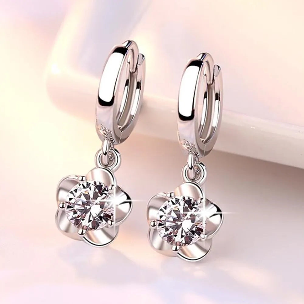 Kessoro women's round white zircon earrings shown in violet and silver tone finishes