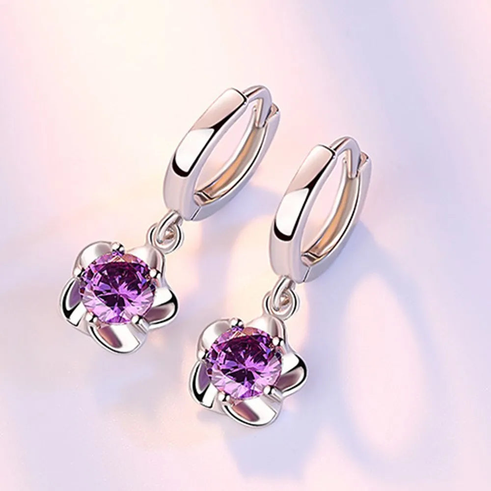Kessoro women's round white zircon earrings shown in violet and silver tone finishes