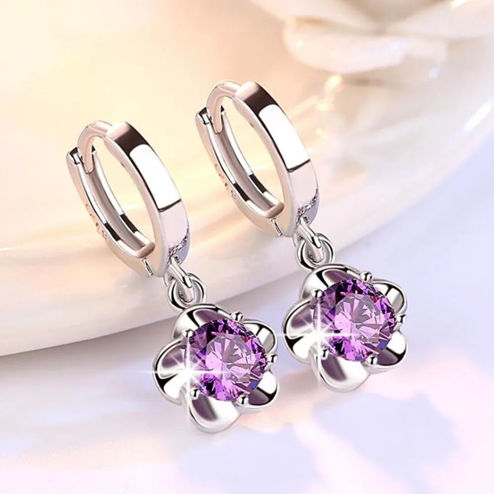 Kessoro women's round white zircon earrings shown in violet and silver tone finishes