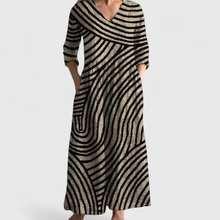 Women's relaxed V-neck dress in a gold and black geometric print with side pockets