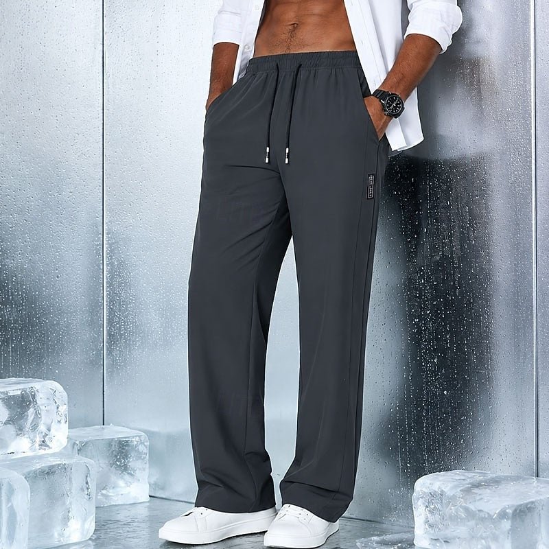 Men's relaxed straight-leg drawstring pants in light grey, black and navy, close-up view