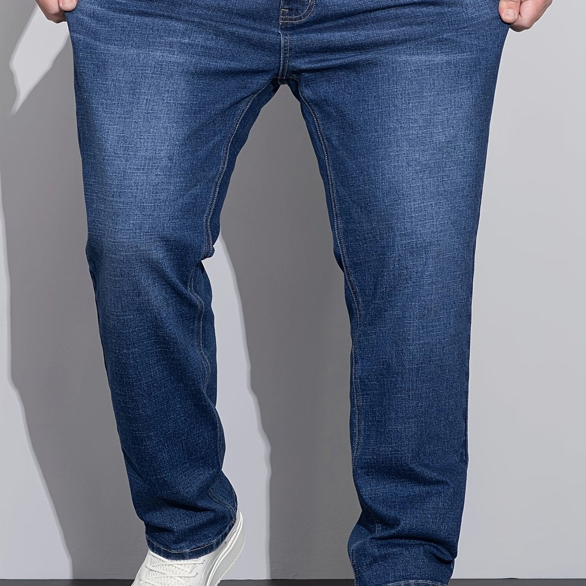 Men's mid-rise straight-leg stretch jeans in blue and black denim, front view