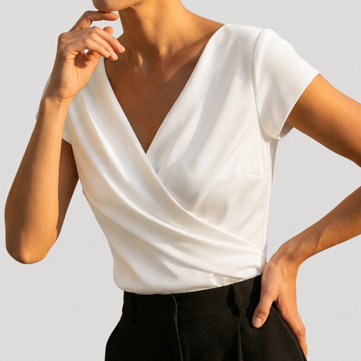 Women's draped wrap-front blouse in white and khaki with a V-neckline, detail view