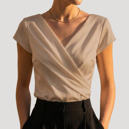 Women's draped wrap-front blouse in white and khaki with a V-neckline, side view