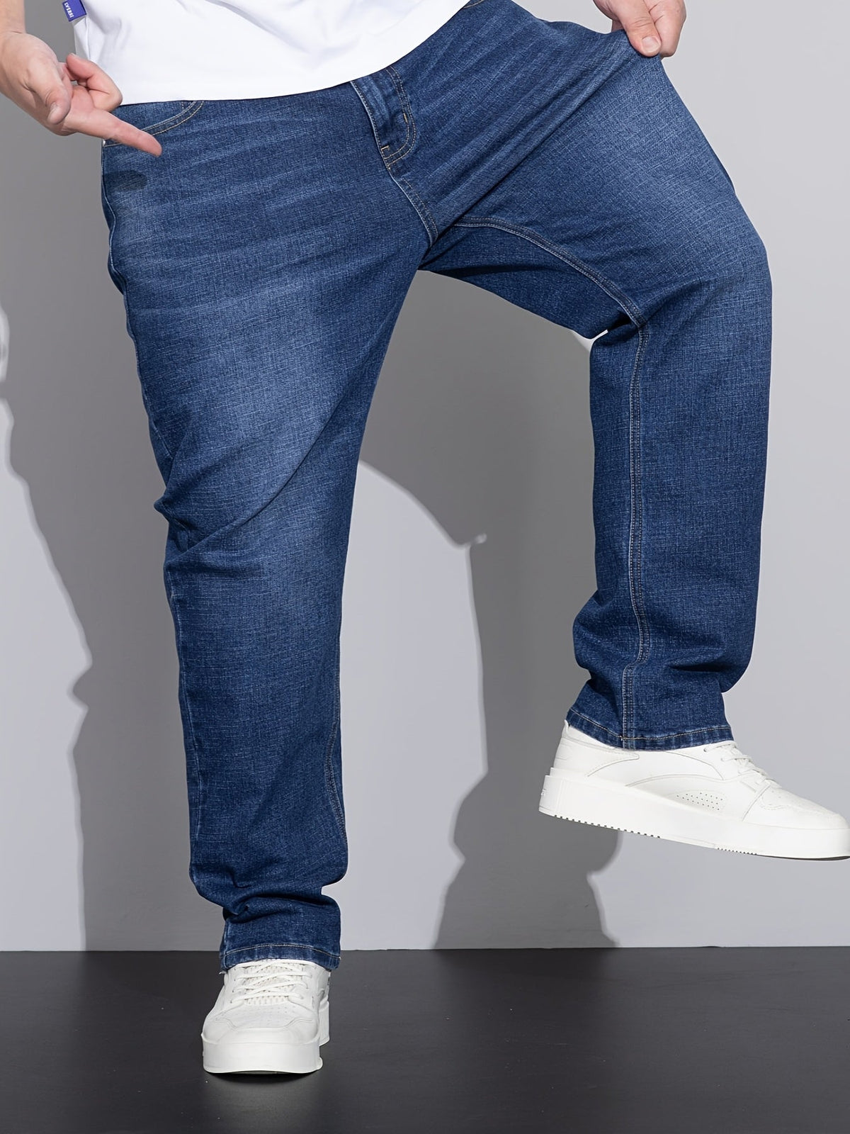Men's mid-rise straight-leg stretch jeans in blue and black denim, colour option 1 back view