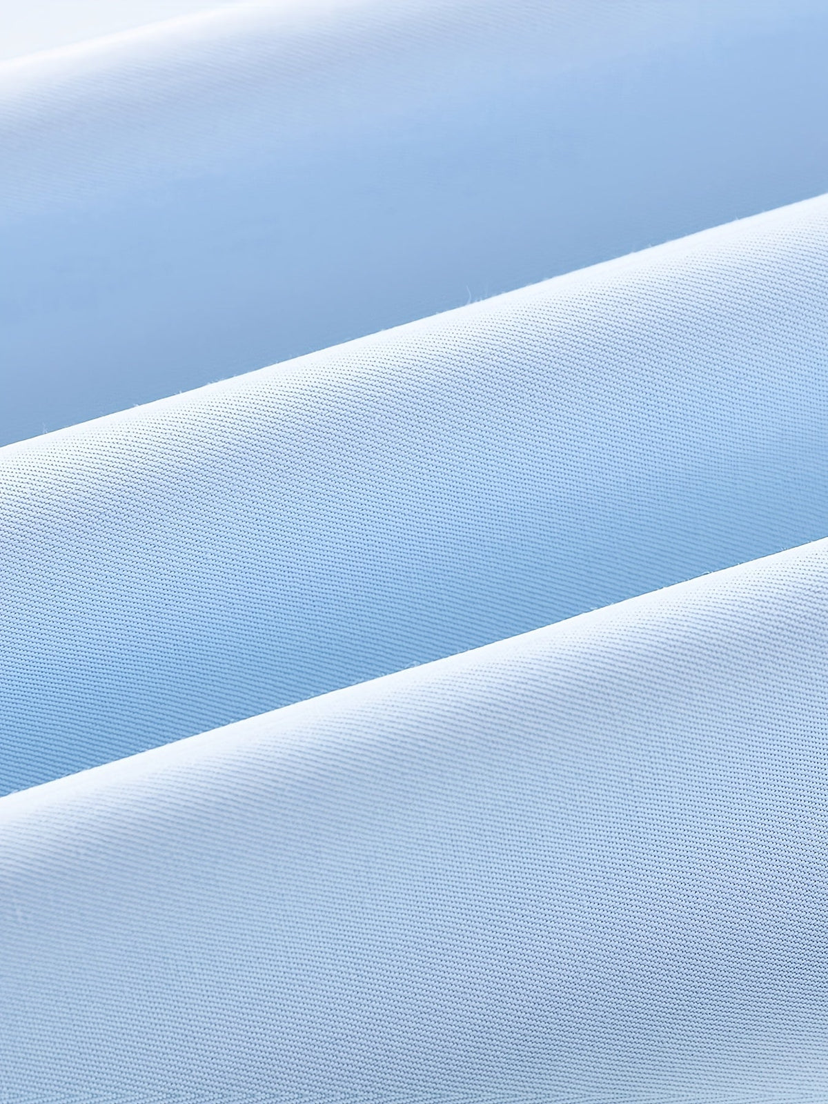 Men's tailored long-sleeve button-up shirt in sky blue, light grey and white, close-up view